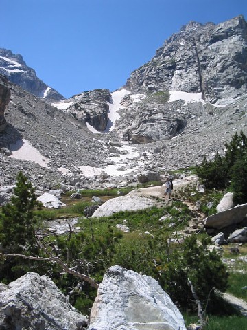 Jeff in The Meadow with the mountain looking down on him from above.