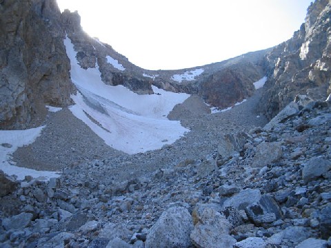 Rocky canyon with what looks like a glacier in the middle of it.