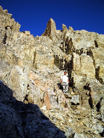 Jeff standing in the middle of a rocky outcropping posing for the picture.